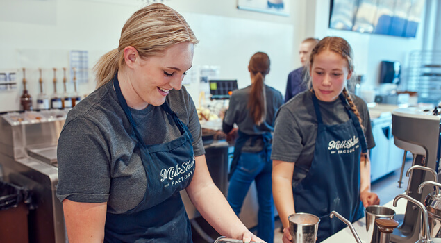 MilkShake Factory in Parramore downtown Orlando - two women prepare milkshakes while two additional team members are shown in the background